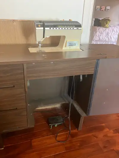 Price Reduced Sewing Machine and Cabinet, View more