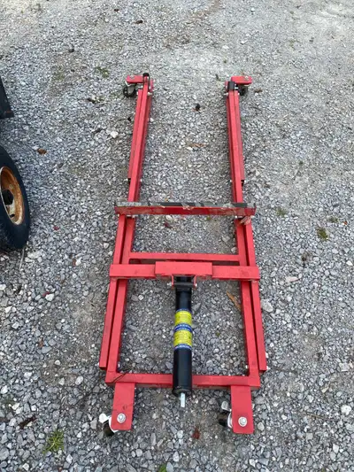 Almost new red snowmobile lift. Some factory plastic still on it. 100$