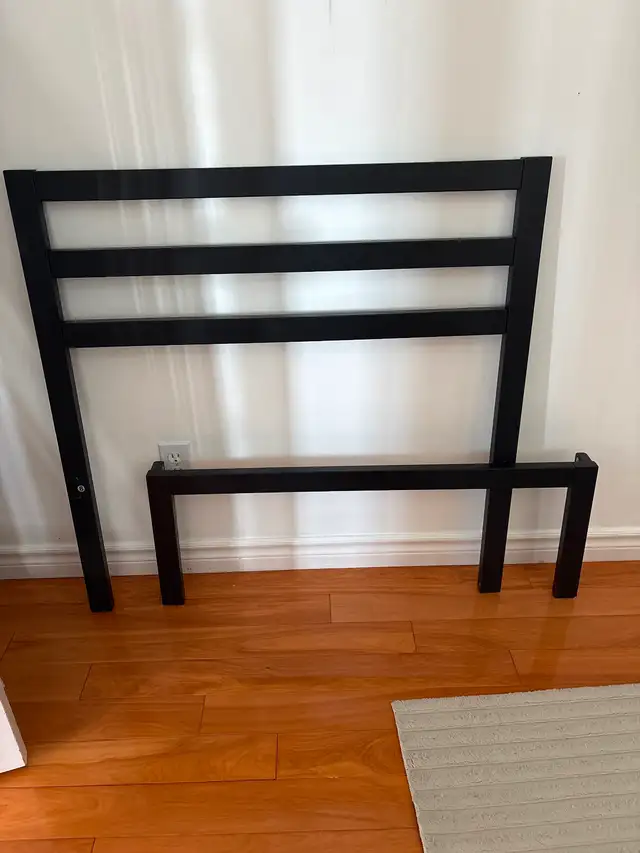 Twin bed frame with rails and slats.