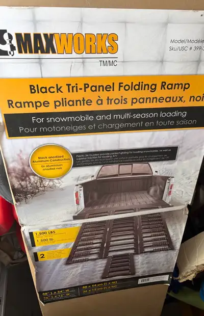 Aluminum ramp for a pickup truck. Never used and still in box. Black folding ramp.