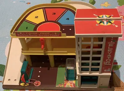 This is a retro fisher price toy in like new shape. The car lift operates with the bell. This is a g...