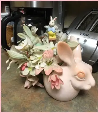 Transcona, near club regent casino. Bunny with silk flowers, used, like new. 7 inch to top of ear, m...
