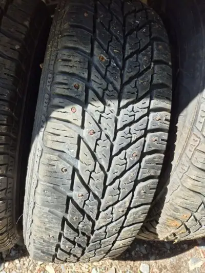 Four Goodyear 195/65R15 Studded Tires on the rims, used for one winter
