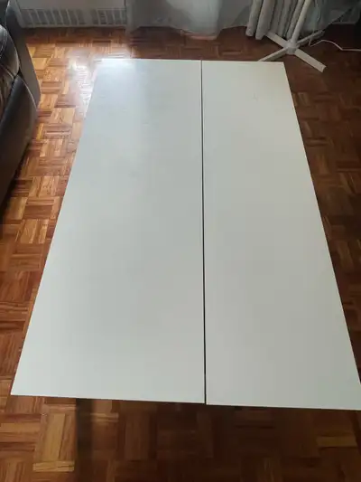 This is a used white IKEA coffee table with a lift top, perfect for maximizing space and functionali...
