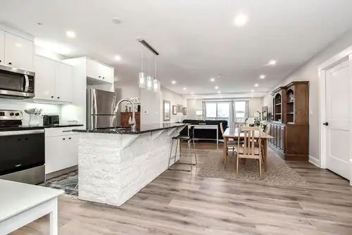 Luxury Apartment in Bedford. Open-concept layout, elegant kitchen with fine intricate molding detail...