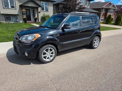 This is a black 2012 Kia Soul 2U, 6 speed manual transmission a versatile and stylish hatchback that...