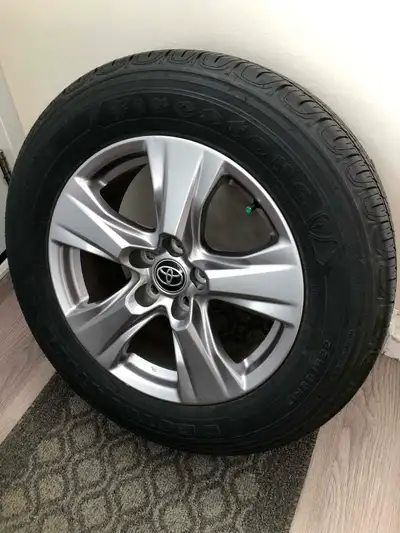 I am selling four 4 Toyota RAV4 new Firestone all season tires 225/65R17 on four Toyota factory allo...