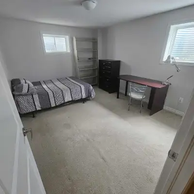This furnished room is available for rent, offering a clean and simple space with neutral-coloured w...