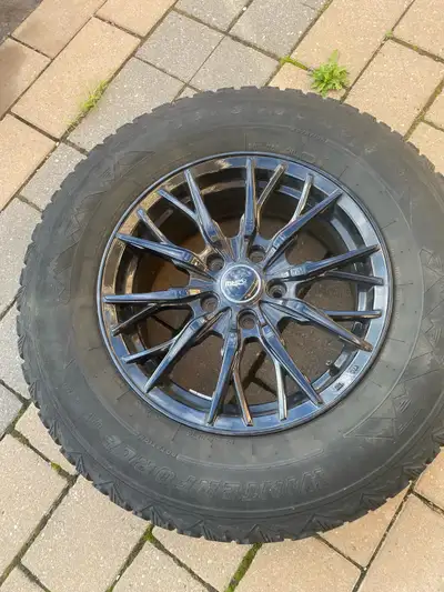 These are four used MRG Winter Force UV winter tires, size P235/70R16 with black rims, ready to tack...