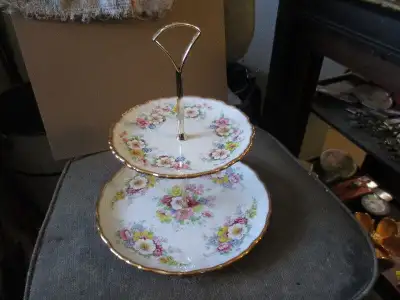 The 2 tier cake platter has been sold...Just picked up this old serving platter with handled cake kn...