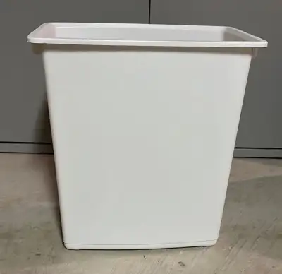 White garbage can. Wastebasket. Some scratching and marks on the bottom. About 15 x 14 x 9”. Handy f...
