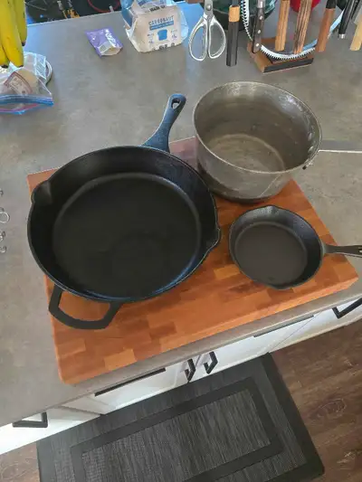 Large cast iron pan Small cast iron pan Aluminum pot Carbon steel pan Great set to cook over the fir...