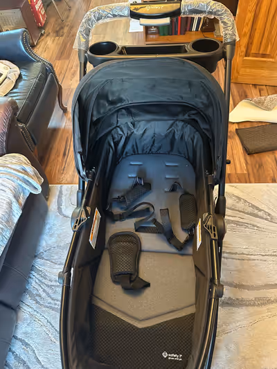 Car seat and stroller. Gray and black colour scheme. Comes with a cup holder. Only used 3-4 times