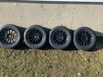 For sale a matching set of p235/60R16 Uniroyal Tiger Paw all season tires on multi bolt 16'' afterma...