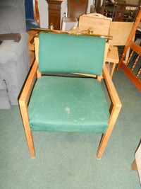 Wood frame chair with arms and green fabric cushions