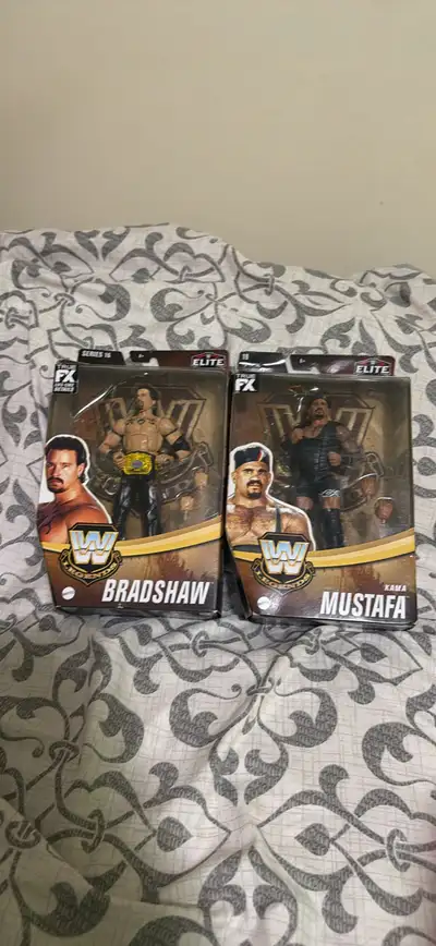 These brand new, never-opened Mattel WWE Legends Series 18 action figures featuring Bradshaw and Mus...