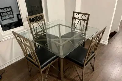 Selling a solid glass dining table with 4 matching metal chairs. Table is 45x45x29.5”, great size fo...