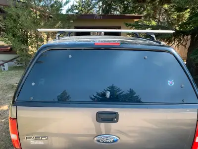 Black Raider Truck Canopy. Fits a 6 foot box. Has Rhino Roof Rack system installed, and comes with 3...