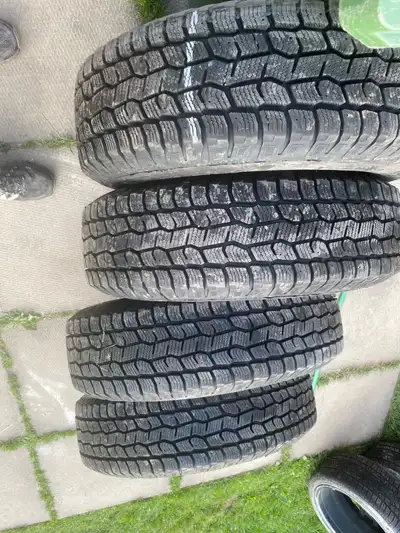 A set of 4 Cooper Winter Tires with tons of tread barley driven like new on Jeep Factory Steel Rims...
