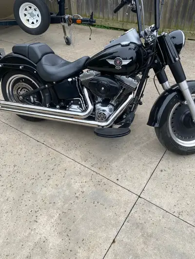 2010 fatboy lo has vance and hines long shots with 14 inch bars. only 22657 kms also have detachable...