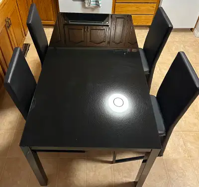 Black glass top kitchen table and 4 chairs Table is: 29.5” tall 55” long 31.5” wide All in good cond...