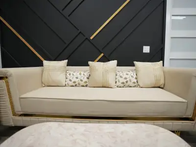 This cream-coloured sofa set is a luxurious addition to any living space, featuring plush seating fo...