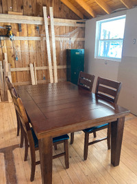 Solid wooden table with four chairs