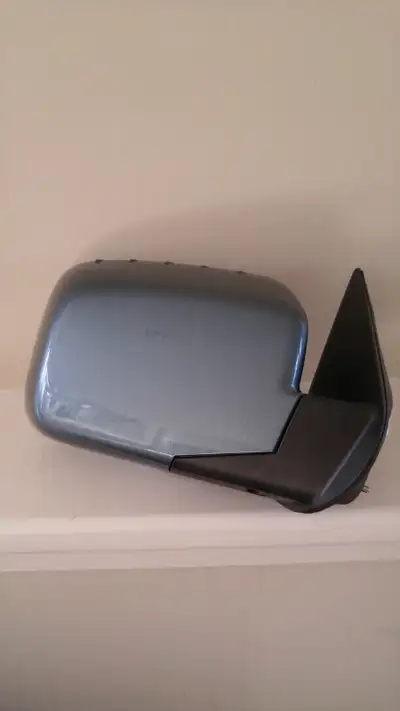New, never used Honda Ridgeline (2006-2008) blue mirror assembly for right hand (passenger) side. It...