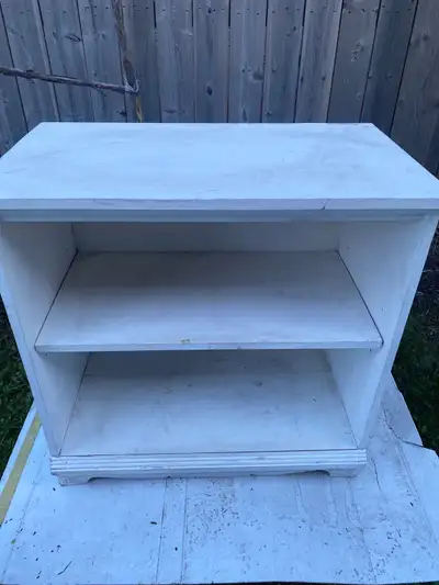This is a sturdy little white bookcase with two shelves, perfect for a child's room or small space....