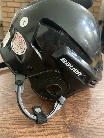 This is a Bauer hockey helmet, ensuring safety and performance on the ice. It's in good condition, r...