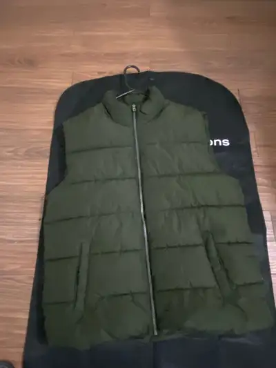 Keep your core warm with this Old Navy olive green puffer vest, perfect for layering during those un...