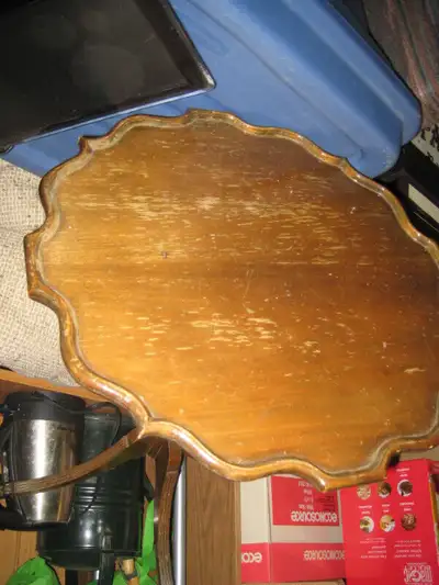 a small round solid wood table and can be used for anything, notebook, or telephone, delicate, some...