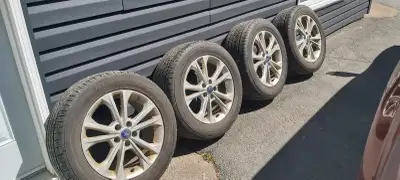 Perfect time for the summer. Set of 235/55R17 all season tires on factory Ford aluminum rims. Tires...