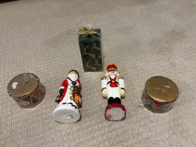 Add nostalgic holiday charm with this festive candle collection! Includes a hand-painted Santa and N...