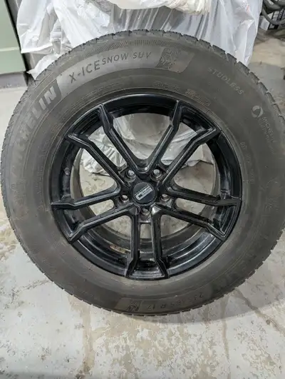 I am offering a set of Michelin X-Ice Snow SUV winter tires mounted on black aluminum rims, size 235...