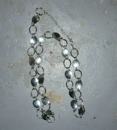 $20 Vintage silver tone steel necklace from the 1970's or 1980's. Links are alternating between text...