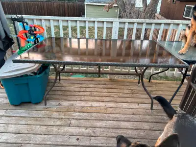 Glass top patio table and 6 chairs. No rust on chairs, no cracks in glass. Comes with 6 grey cushion...