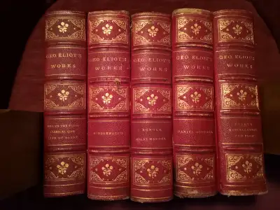 1887 Geo Eliot 5 book set of his works. In good shape but one volume has a scrape on the front cover...