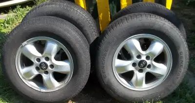 A set of four 225-65-R16 tires on Santa Fe rims. The rims are in very good condition. Lots of tread...