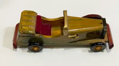 Handcrafted wooden toy car with a polished finish. This vintage-style model is made of wood and feat...