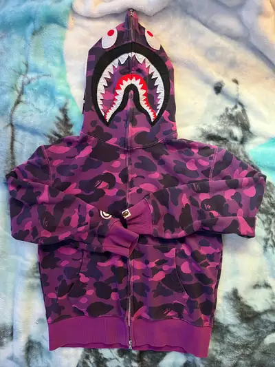 I'm selling a stylish and vibrant purple Bape hoodie, perfect for adding a pop of colour to your str...