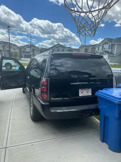 This GMC Yukon XL Denali is a spacious and reliable SUV, featuring a powerful engine and a comfortab...