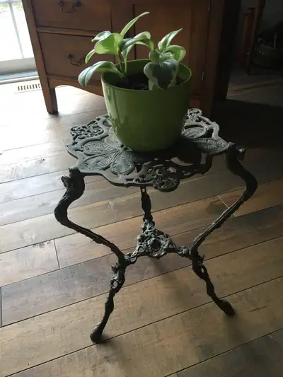 Beautiful and unique vintage brass plant stand on three out-swept legs decorated with flowers and le...