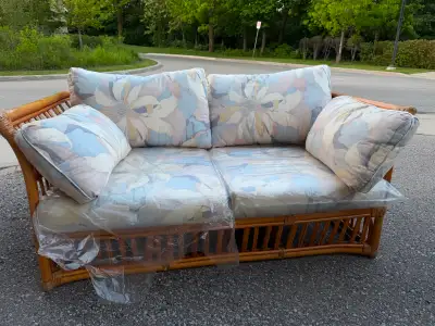 Vintage rattan / wicker loveseat sofa with matching floral cushi, View more