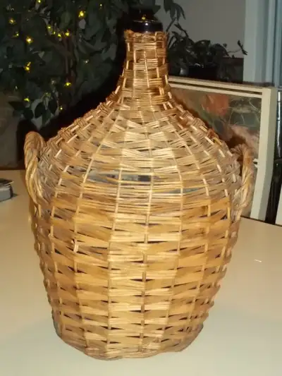 Ancienne cruche dîte "Dame-Jeanne ou Marie-Jeanne" en verre foncé soufflée dans de l'osier tressé à...