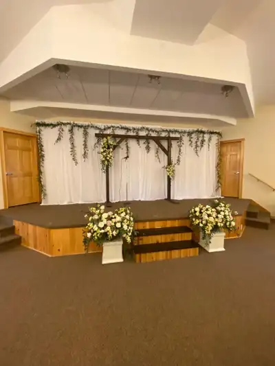 20’ long by 8 1/2” high wedding backdrop. Sheer ivory curtains with white twinkle lights and white s...