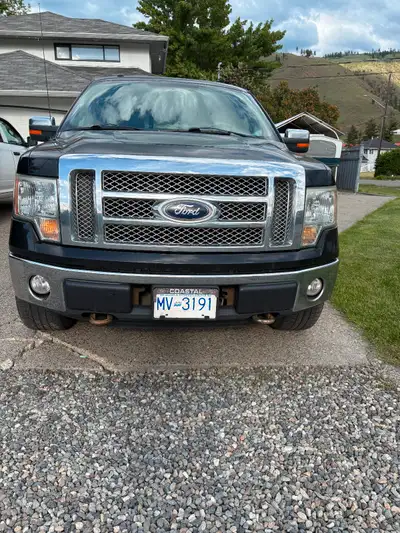 Well used black f-150 lariat, roll steel tonneau cover