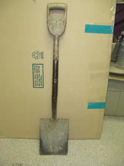 Antique wooden-handled shovel with square shovel blade. Some cracking in the handle and wear and tea...