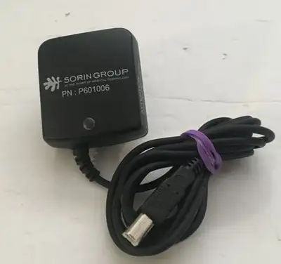 This is a Sorin Group AC/DC Adapter, type FW7660M/05. Input: 100-240V, 50-60Hz, 205-110mA, output: 5...