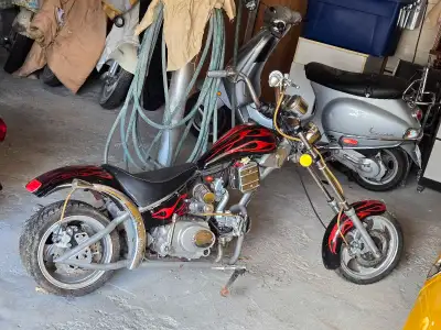 Rev up your engines for this Mini CHOPPER, a compact motorcycle with a vibrant red flame design, per...